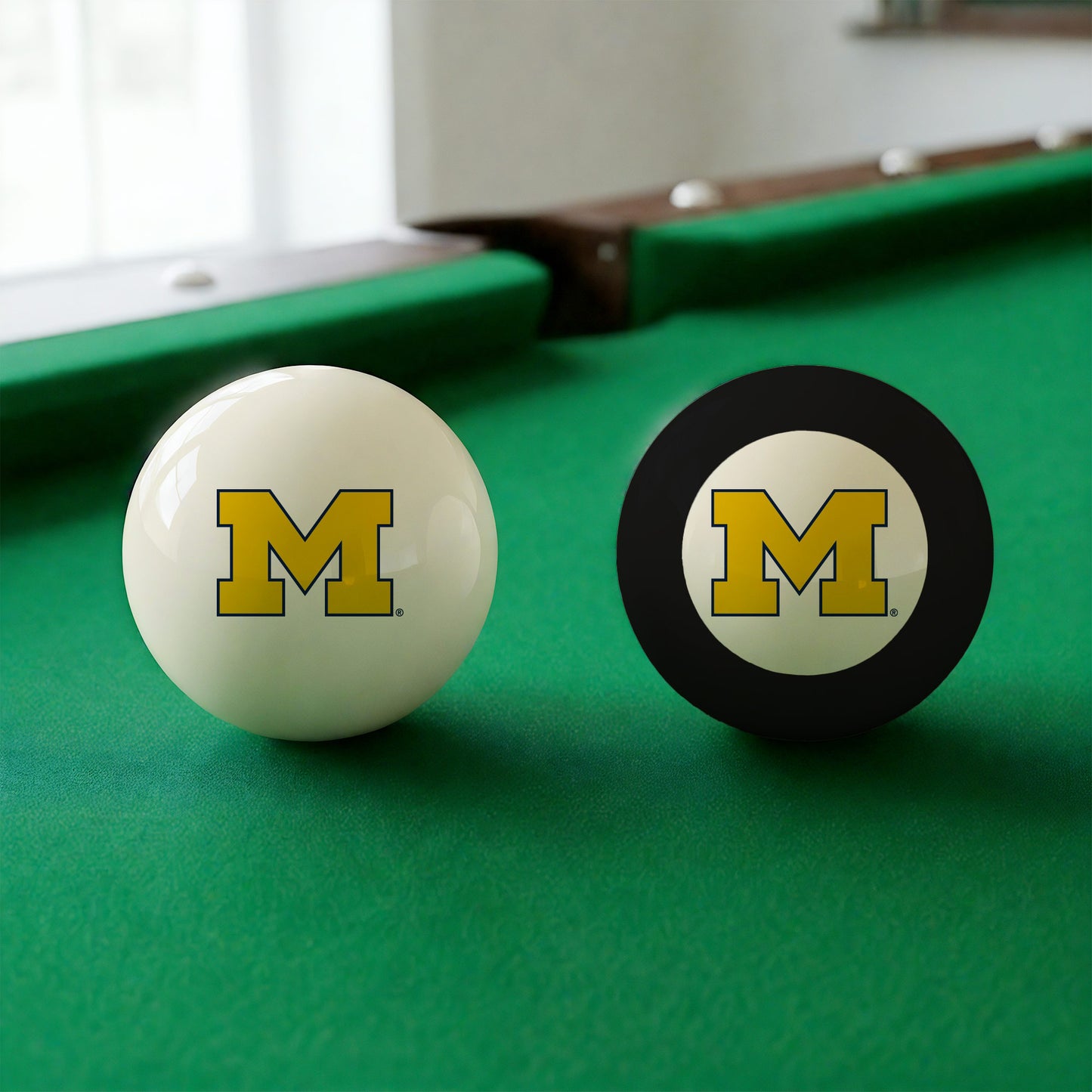 Official Michigan-Wolverines-Pool-Cue-8-Ball-Set College Cue Ball and 8-Ball Set Displayed Together on Green Felt Pool Table Surface