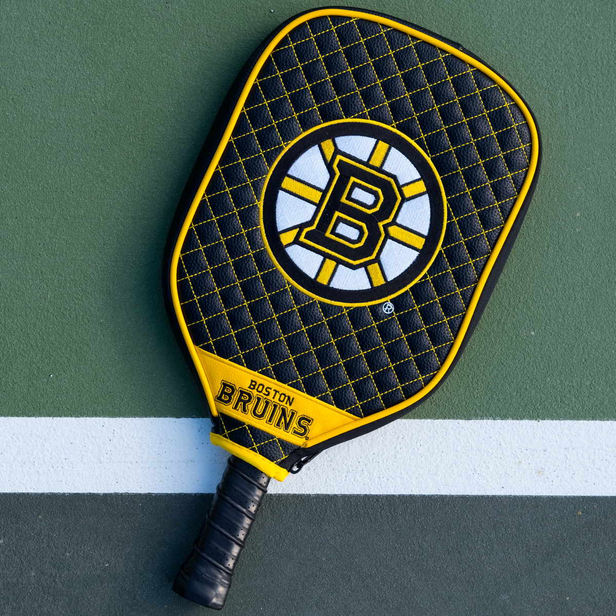 Boston Bruins quilted pickleball paddle cover on court view