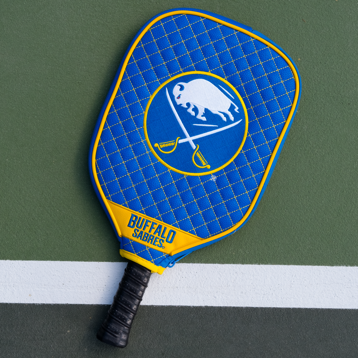 Buffalo Sabres quilted pickleball paddle cover on court view