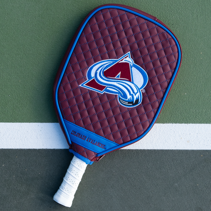 Colorado Avalanche Maroon quilted pickleball paddle cover on court