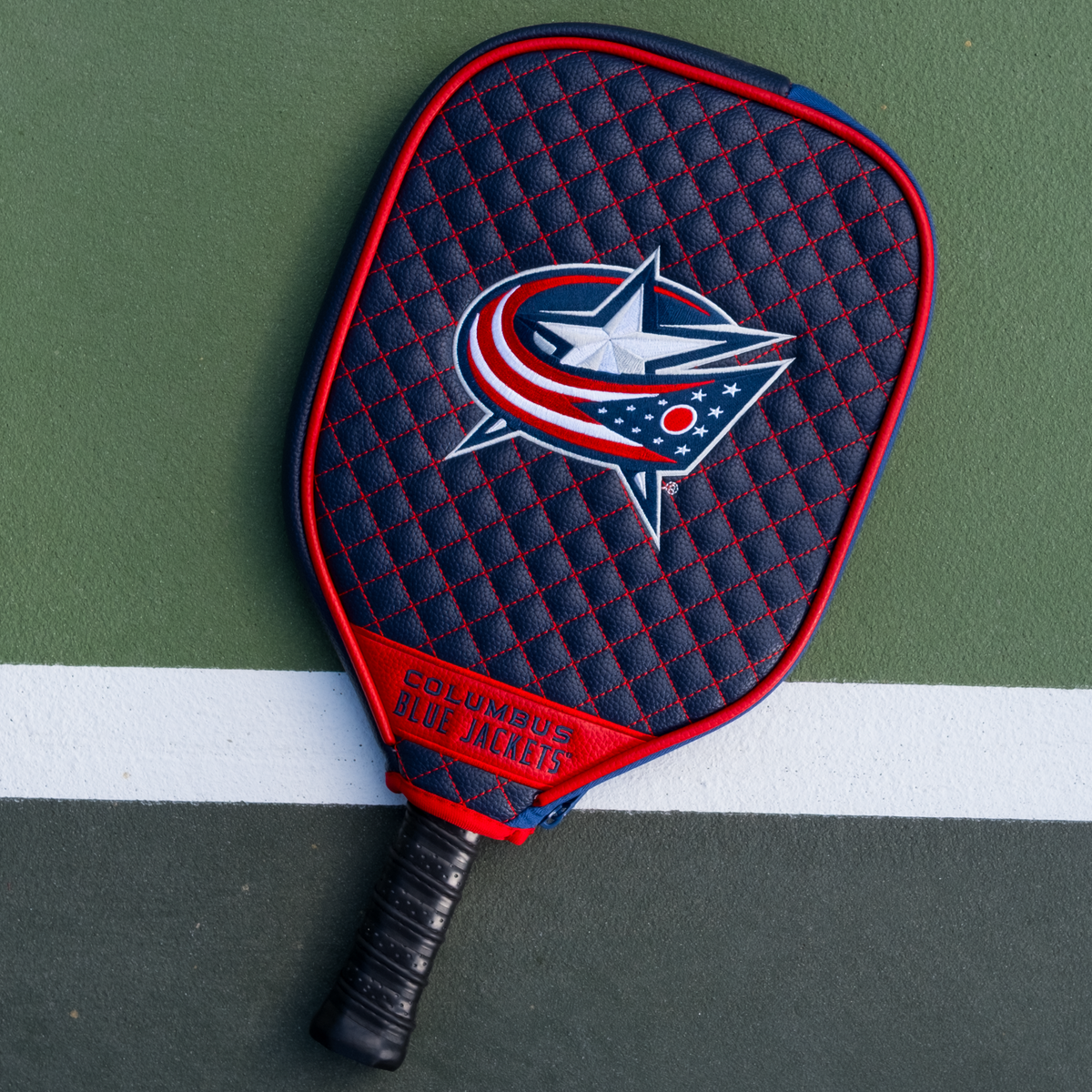 Columbus Blue Jackets quilted pickleball paddle cover on court view