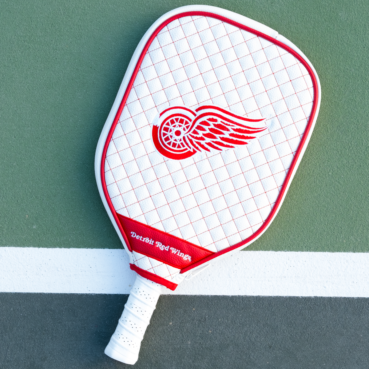 Detroit Red Wings White quilted pickleball paddle cover on court