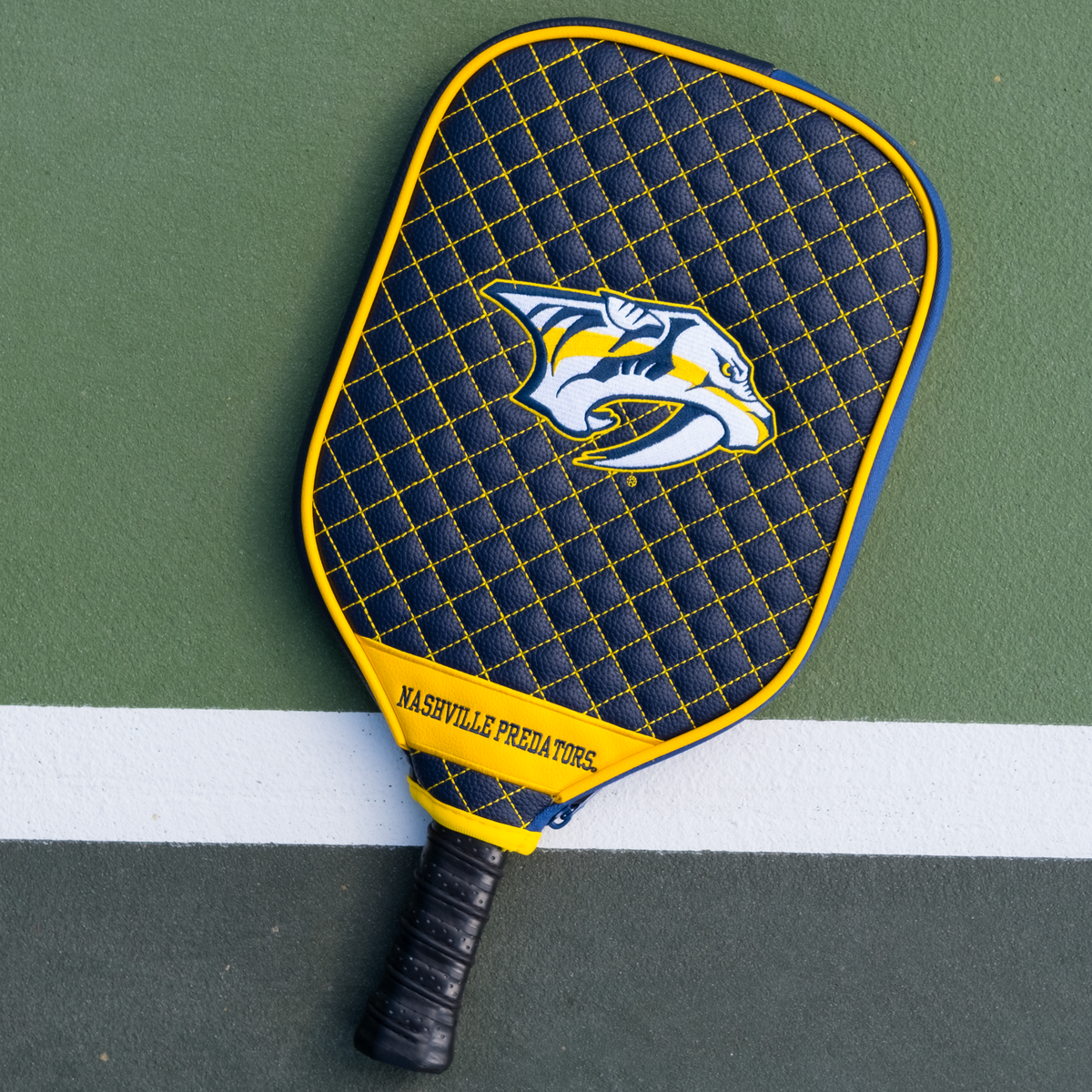 Nashville Predators quilted pickleball paddle cover on court view