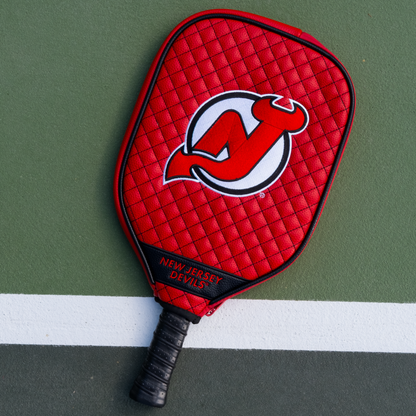 New Jersey Devils Red quilted pickleball paddle cover on court