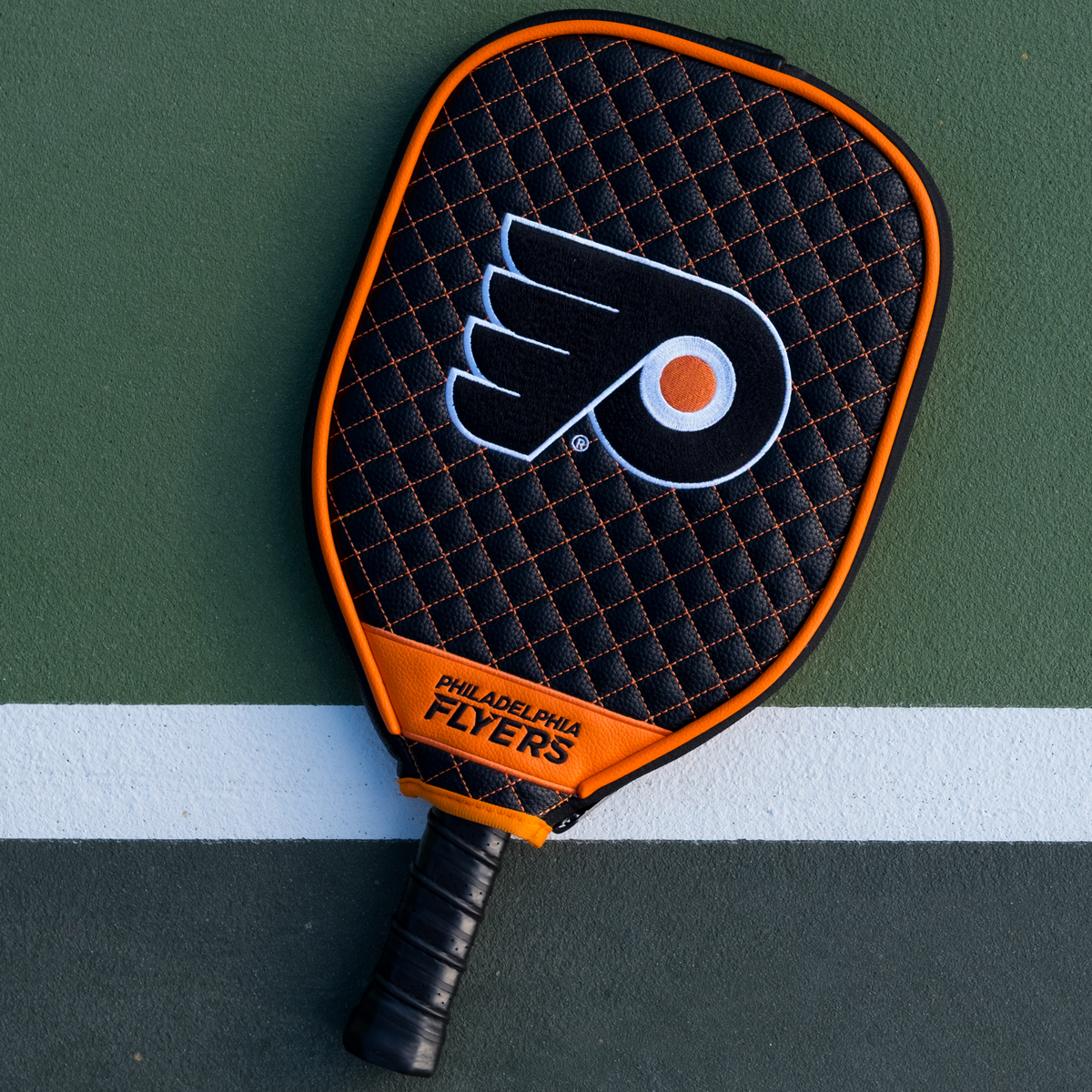 Philadelphia Flyers Black quilted pickleball paddle cover on court