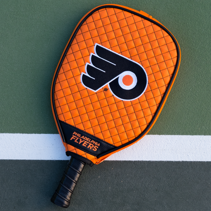 Philadelphia Flyers Orange quilted pickleball paddle cover on court
