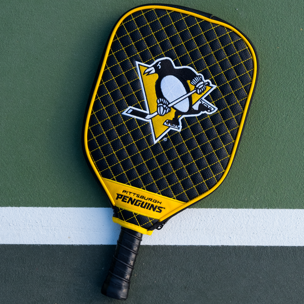 Pittsburgh Penguins quilted pickleball paddle cover on court view