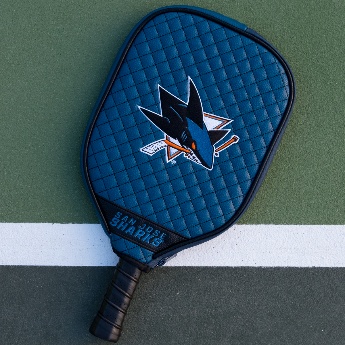 San Jose Sharks Teal quilted pickleball paddle cover on court