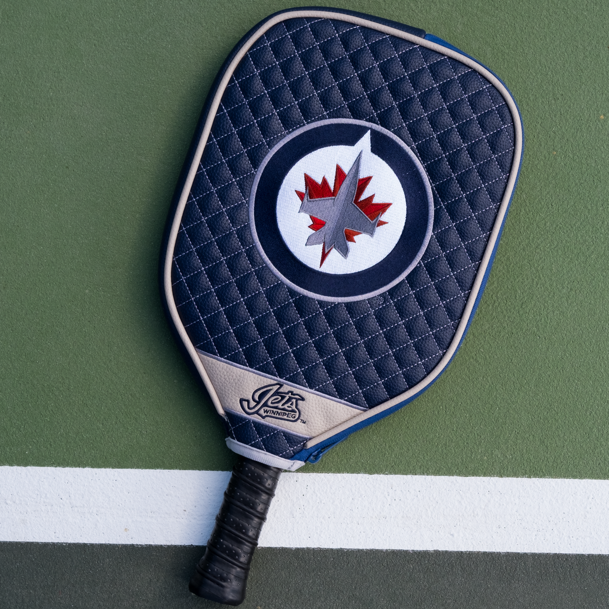 Winnipeg Jets quilted pickleball paddle cover on court view