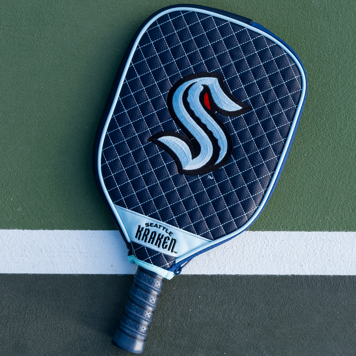 Seattle Kraken quilted pickleball paddle cover on court view