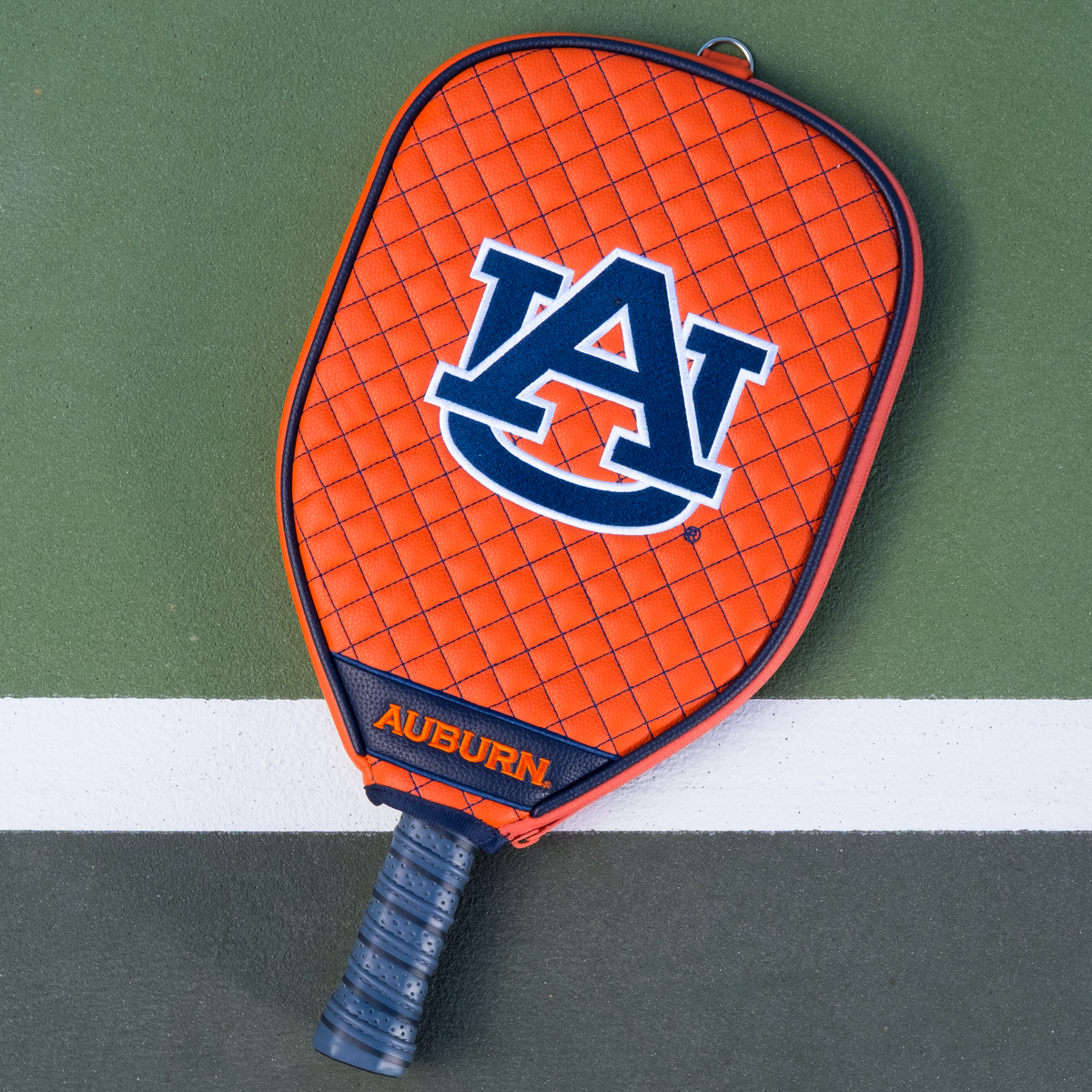 Auburn Tigers Orange quilted pickleball paddle cover on court