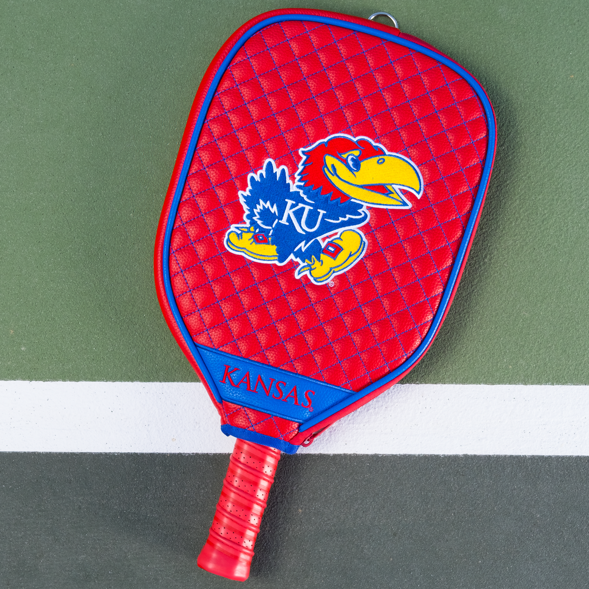 Kansas Jayhawks Red quilted pickleball paddle cover on court