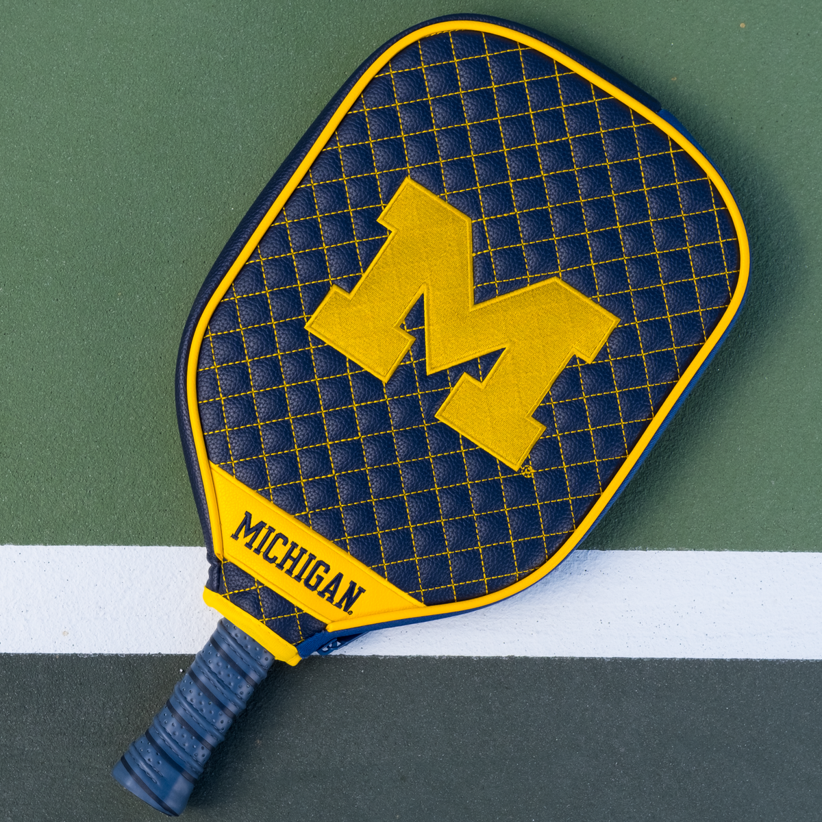 Michigan Wolverines quilted pickleball paddle cover on court view