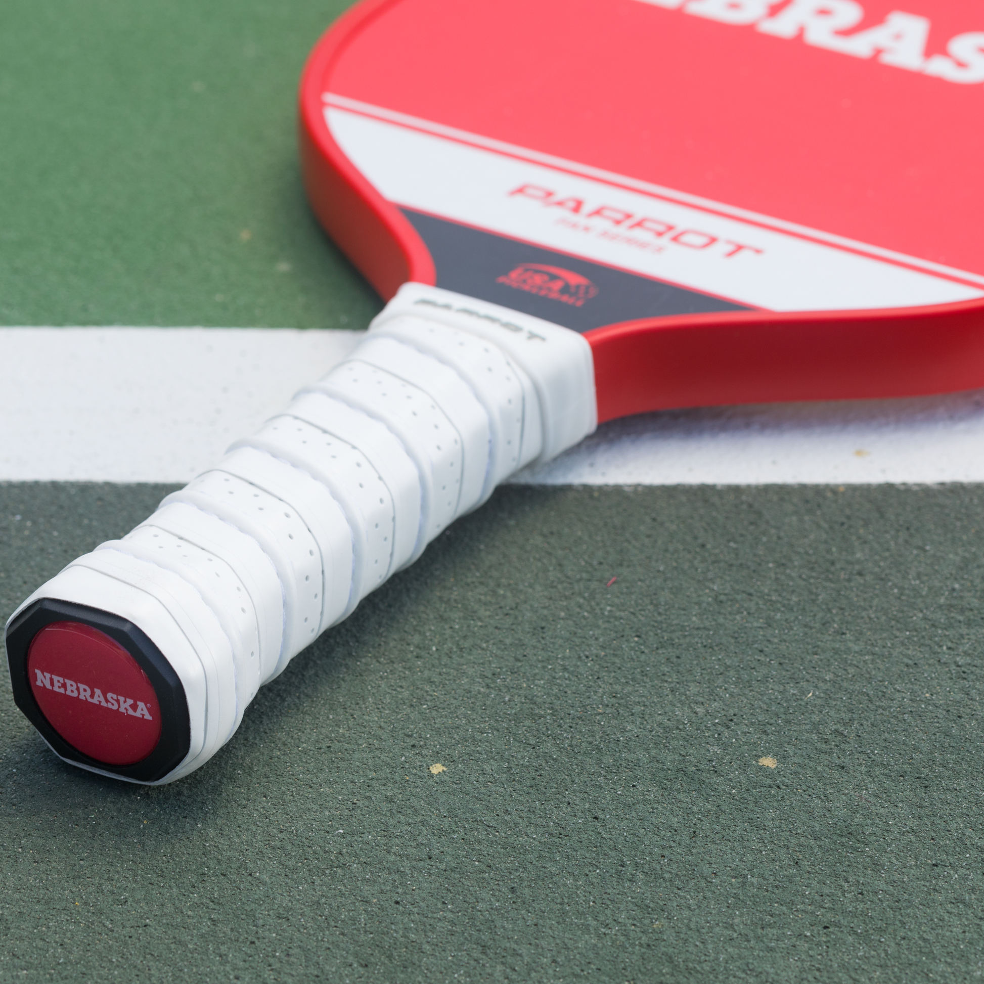 Nebraska Cornhuskers Sport Plus pickleball paddle on the court
