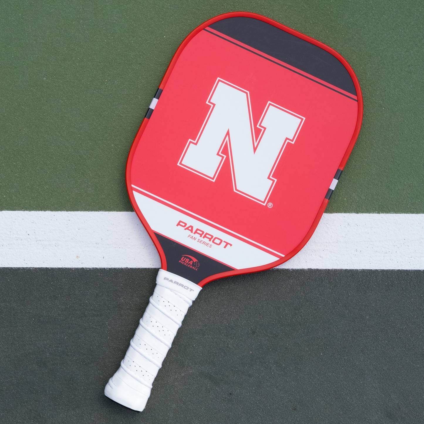 Nebraska Cornhuskers Sport Plus pickleball paddle back view on the court