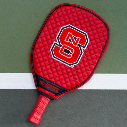 NC State Wolfpack quilted pickleball paddle cover on court view