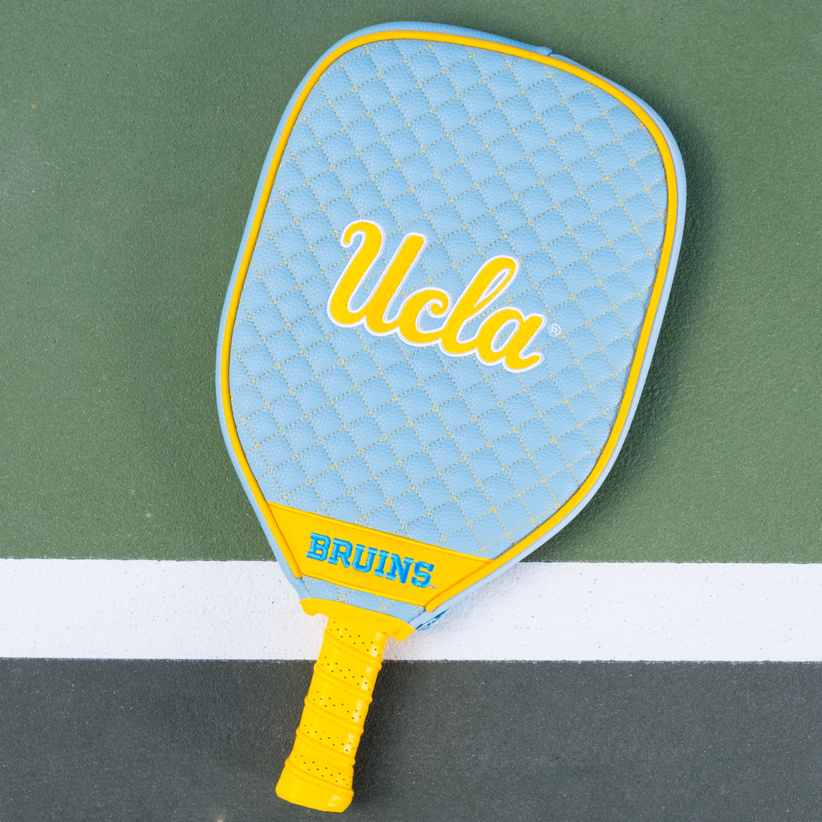 UCLA Bruins quilted pickleball paddle cover on court view