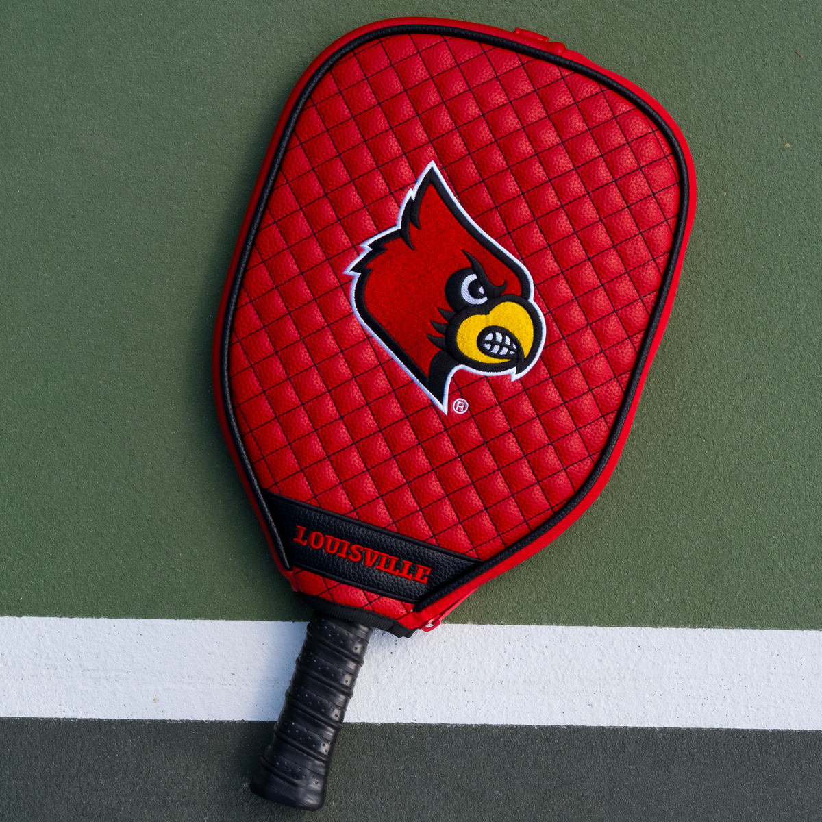 Louisville Cardinals quilted pickleball paddle cover on court view