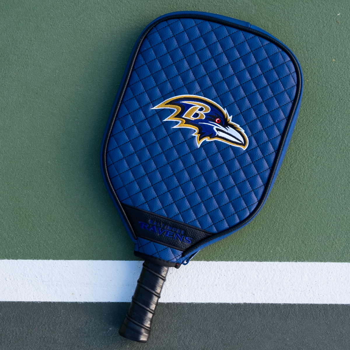 Baltimore Ravens quilted pickleball paddle cover on court view
