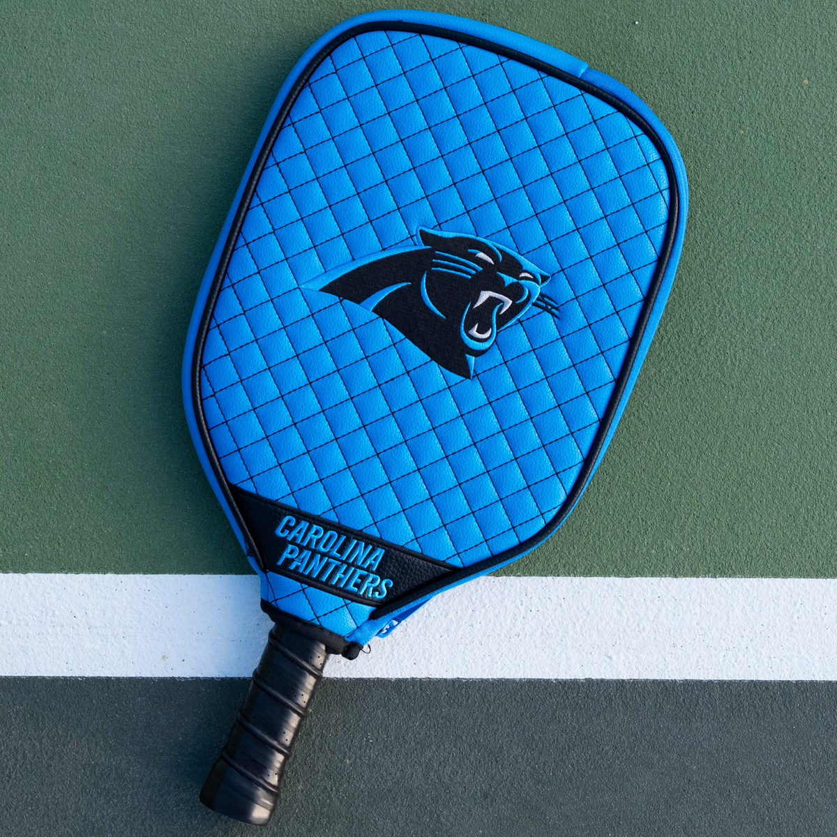 Carolina Panthers quilted pickleball paddle cover on court view