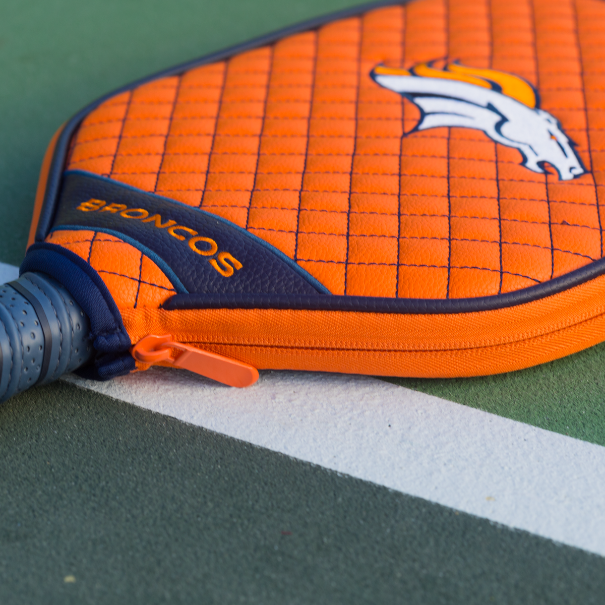 Denver Broncos Orange quilted pickleball paddle cover closeup image