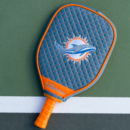 Miami Dolphins Teal quilted pickleball paddle cover on court