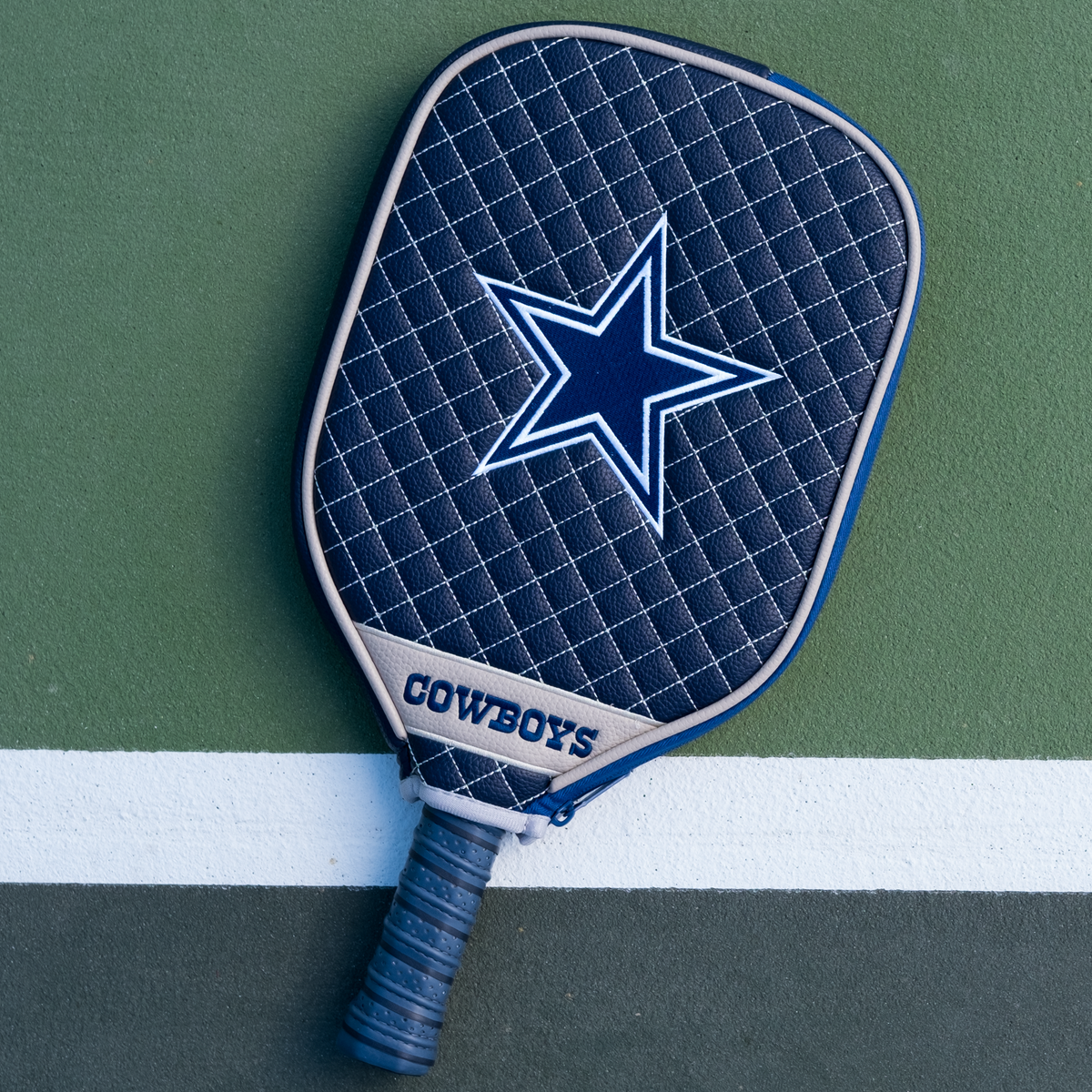 Dallas Cowboys Navy quilted pickleball paddle cover on court