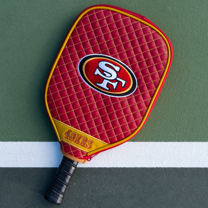 San Francisco 49ers quilted pickleball paddle cover on court view