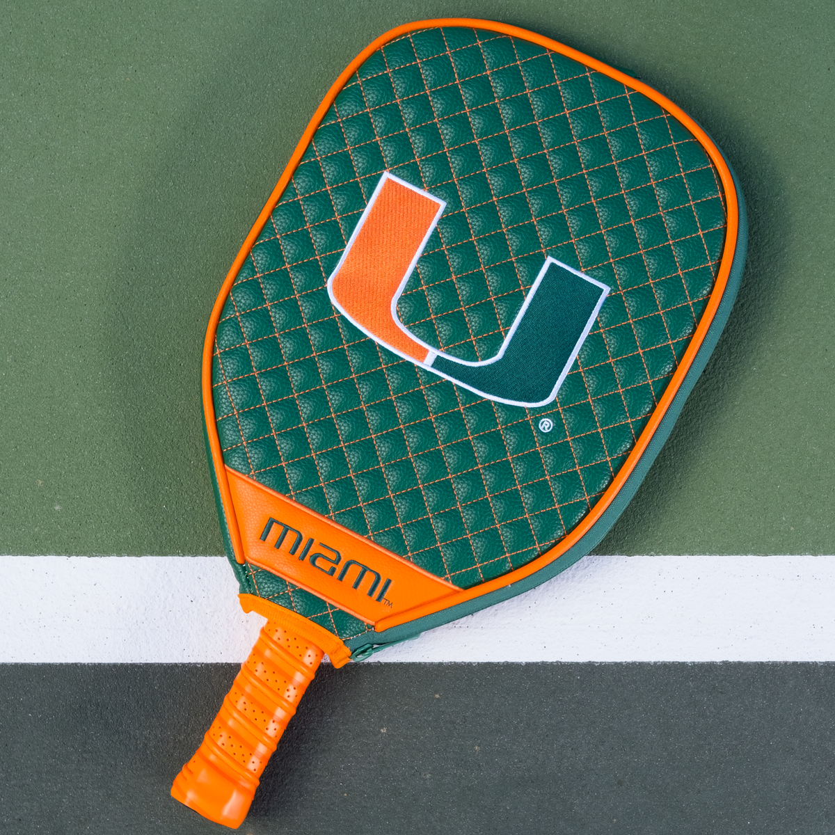 Miami Hurricanes quilted pickleball paddle cover on court view