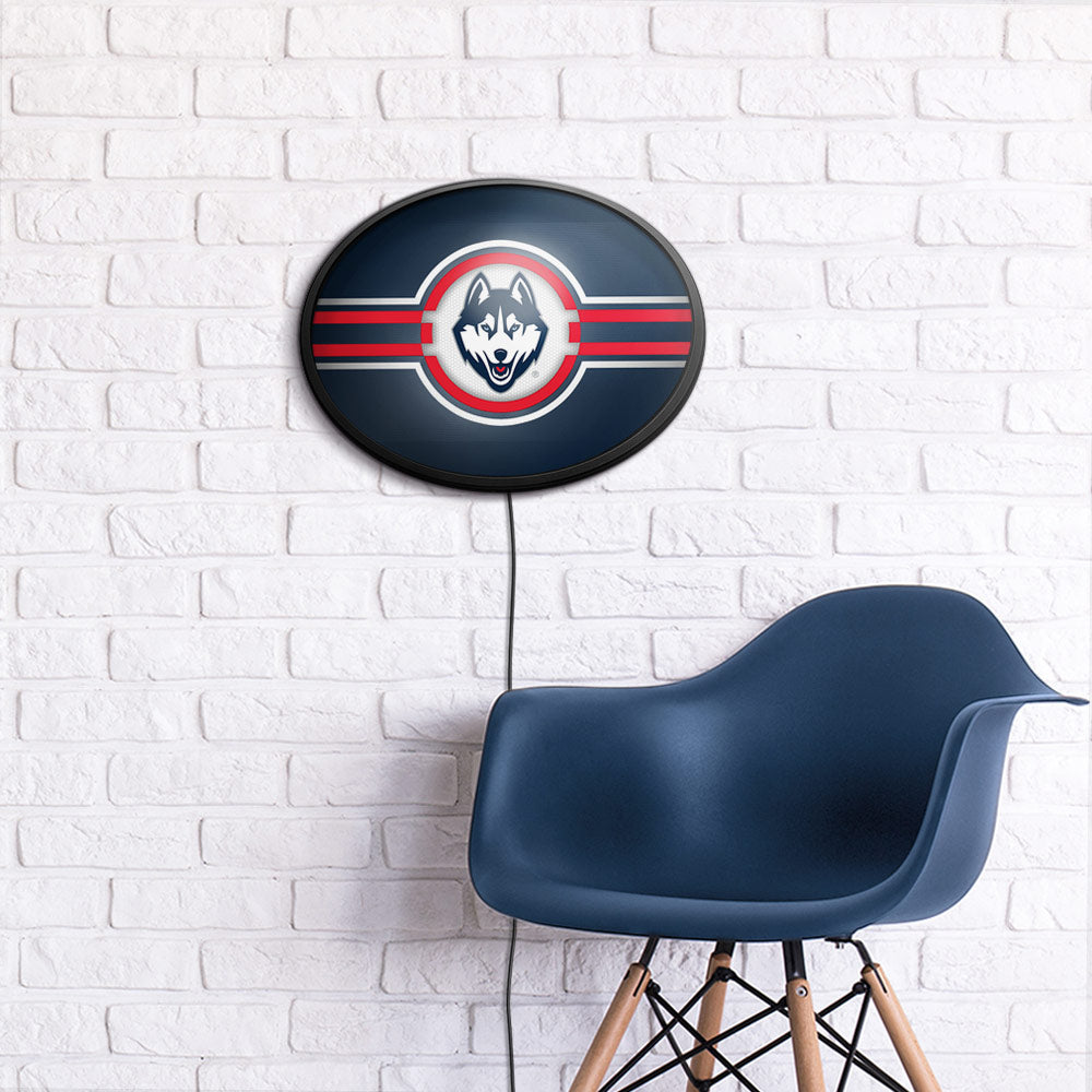 Connecticut Huskies Slimline Oval Lighted Wall Sign Room View